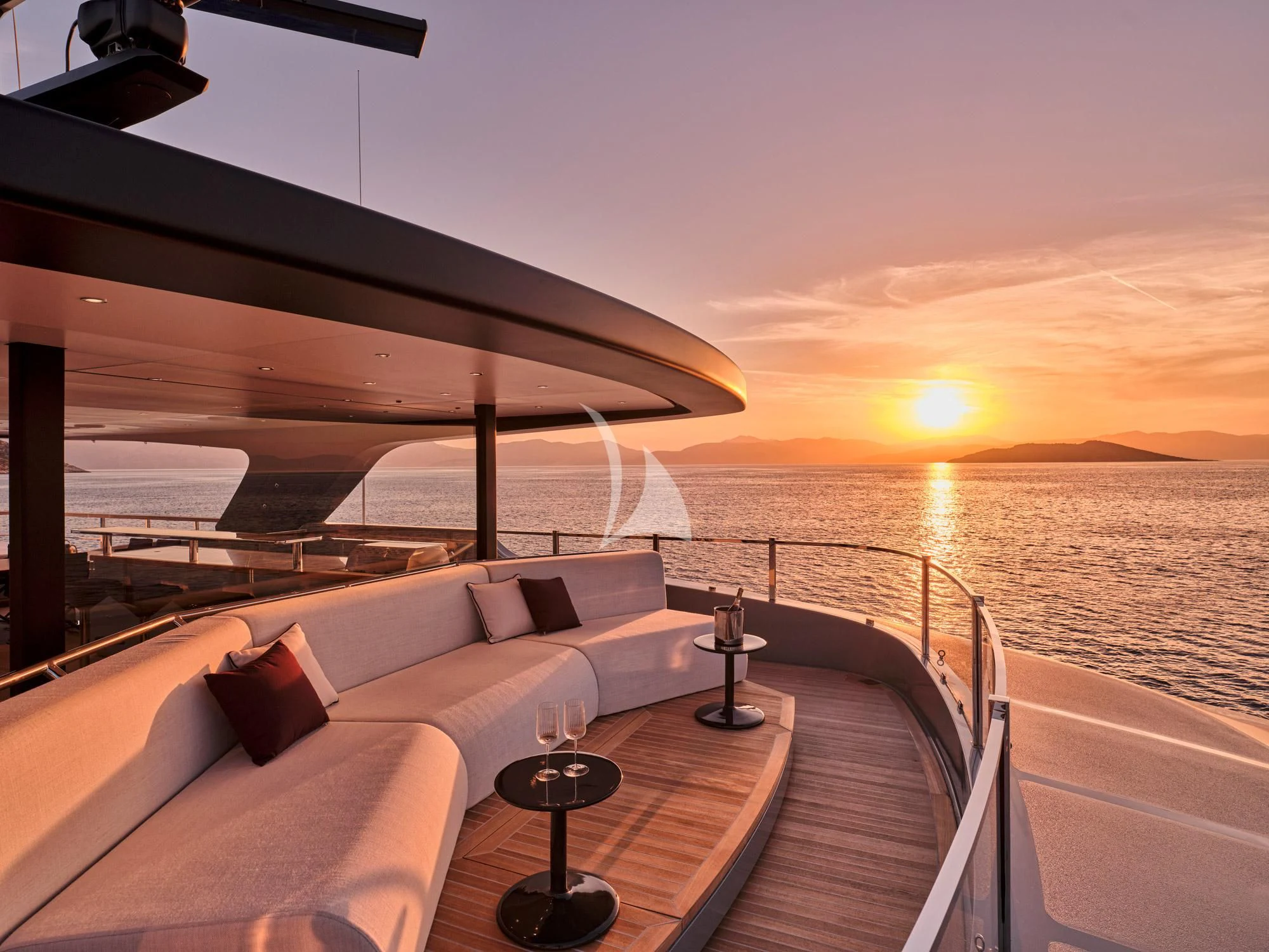 a deck with a view of the sunset and the ocean aboard PARA BELLVM Yacht for Charter