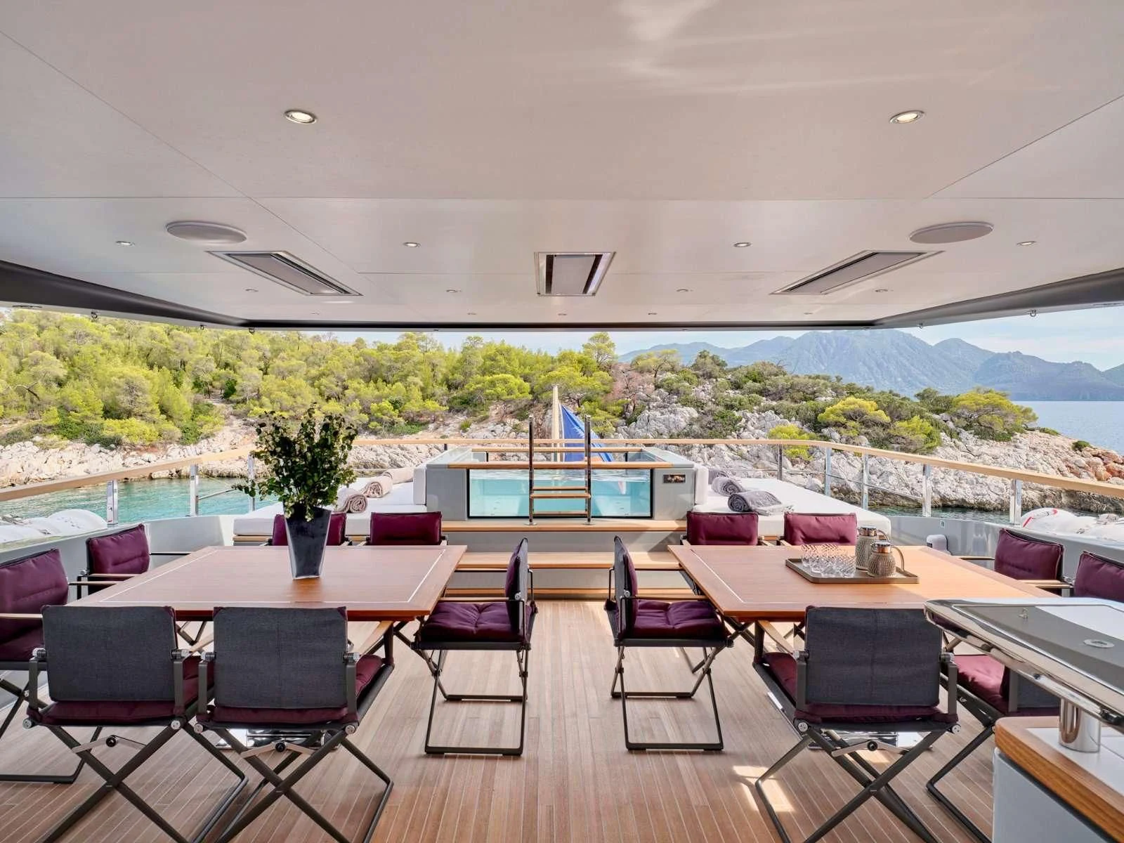 a room with tables and chairs aboard PARA BELLVM Yacht for Charter