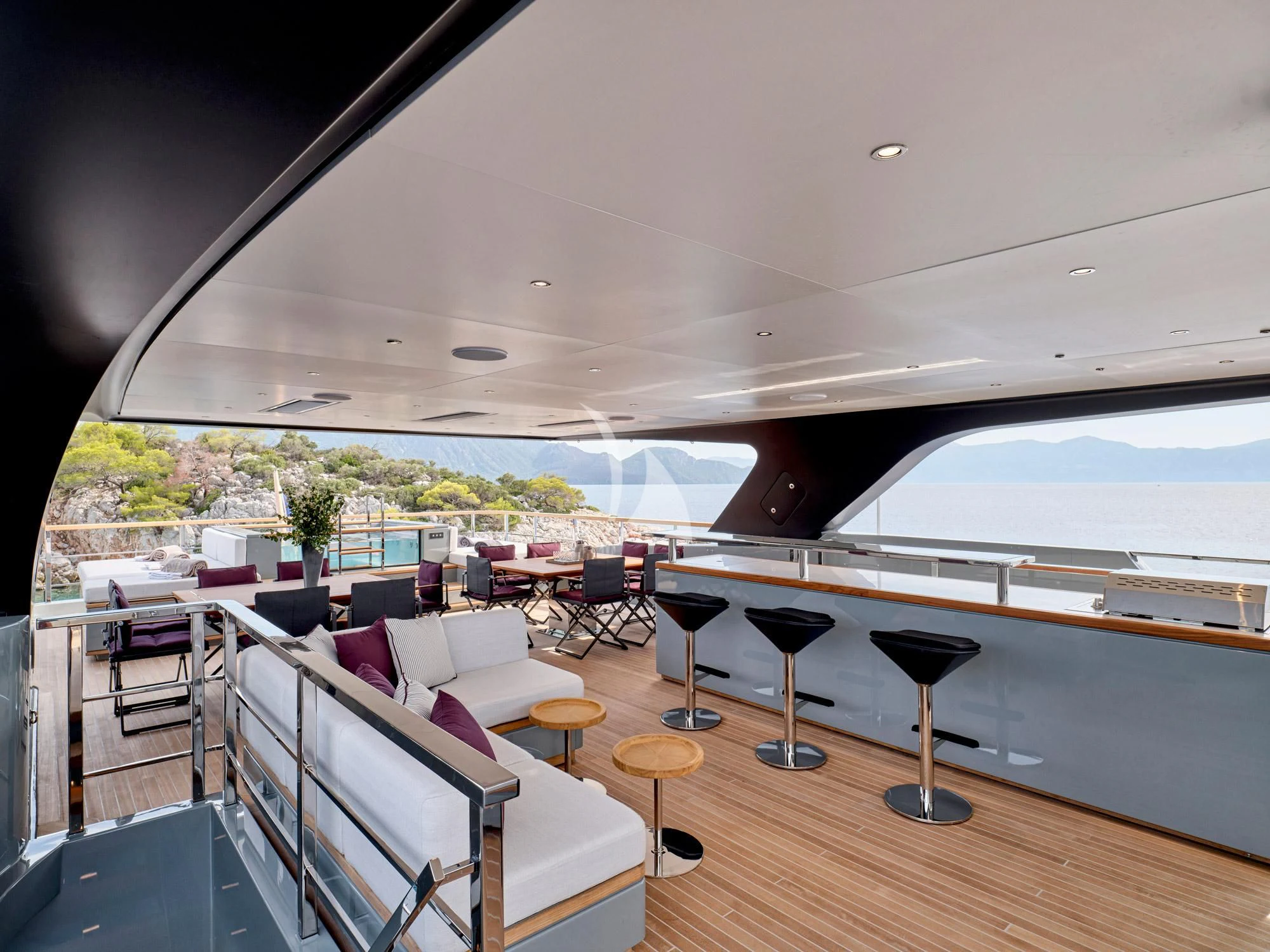 a room with a table chairs and a window aboard PARA BELLVM Yacht for Charter