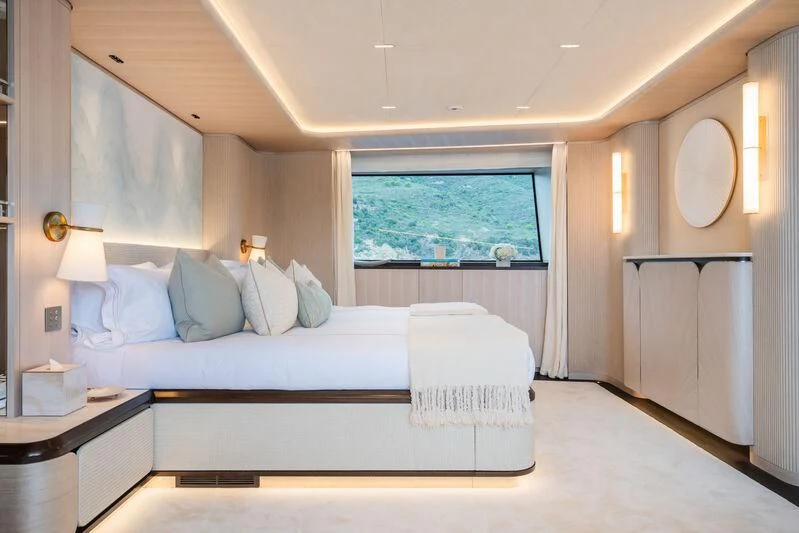 a room with a bed and a window aboard PARA BELLVM Yacht for Charter