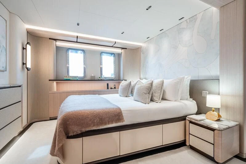 a bed with a white bed spread aboard PARA BELLVM Yacht for Charter