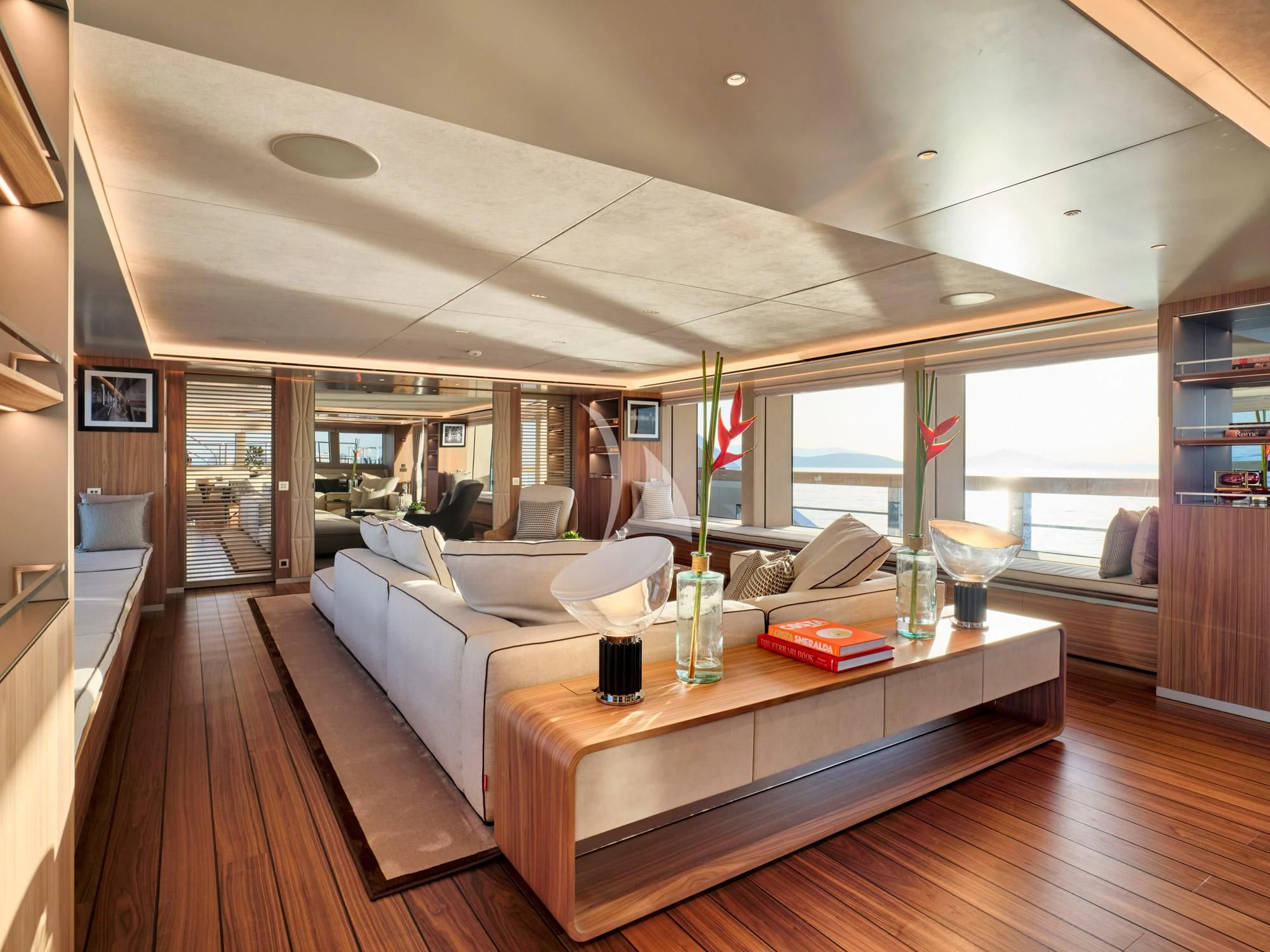 a room with a large bed and a table with chairs aboard PARA BELLVM Yacht for Charter
