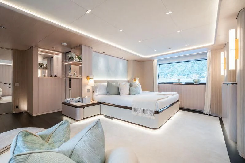 a bedroom with a bed and a window aboard PARA BELLVM Yacht for Charter