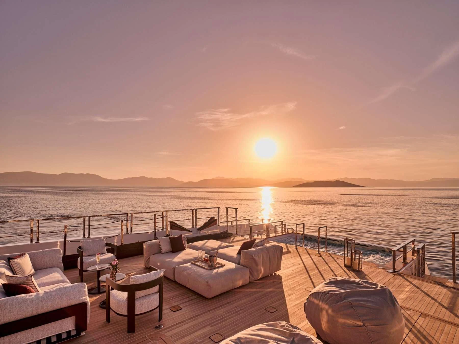 a deck with chairs and a body of water in the background aboard PARA BELLVM Yacht for Charter