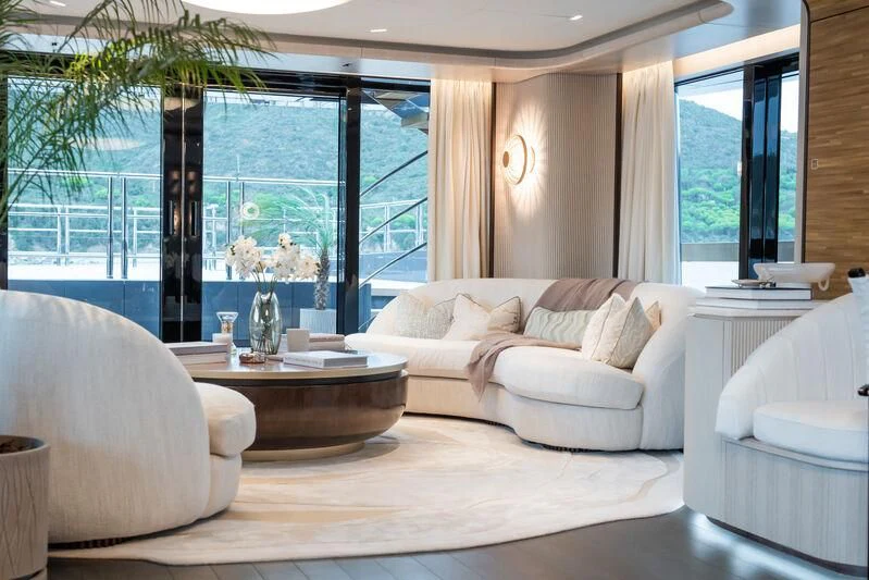 a living room with a large window aboard PARA BELLVM Yacht for Charter