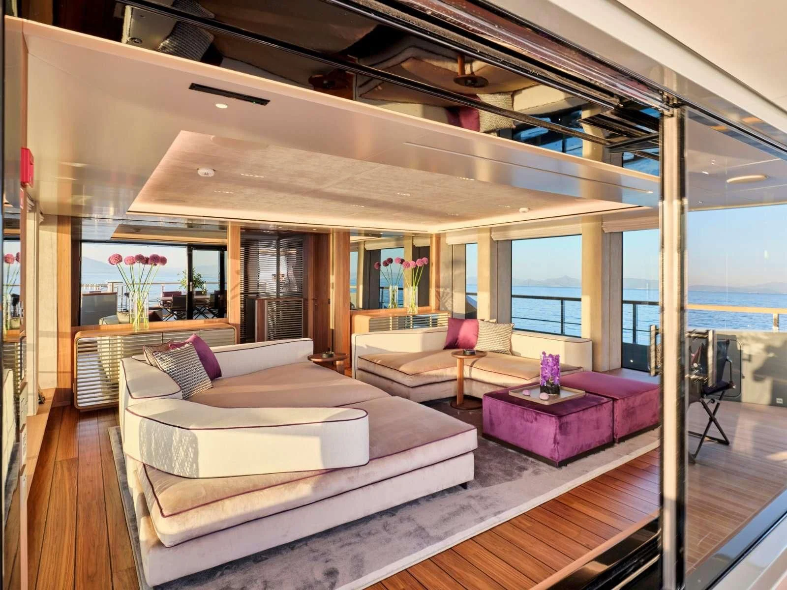 a modern living room with a large open window aboard PARA BELLVM Yacht for Charter