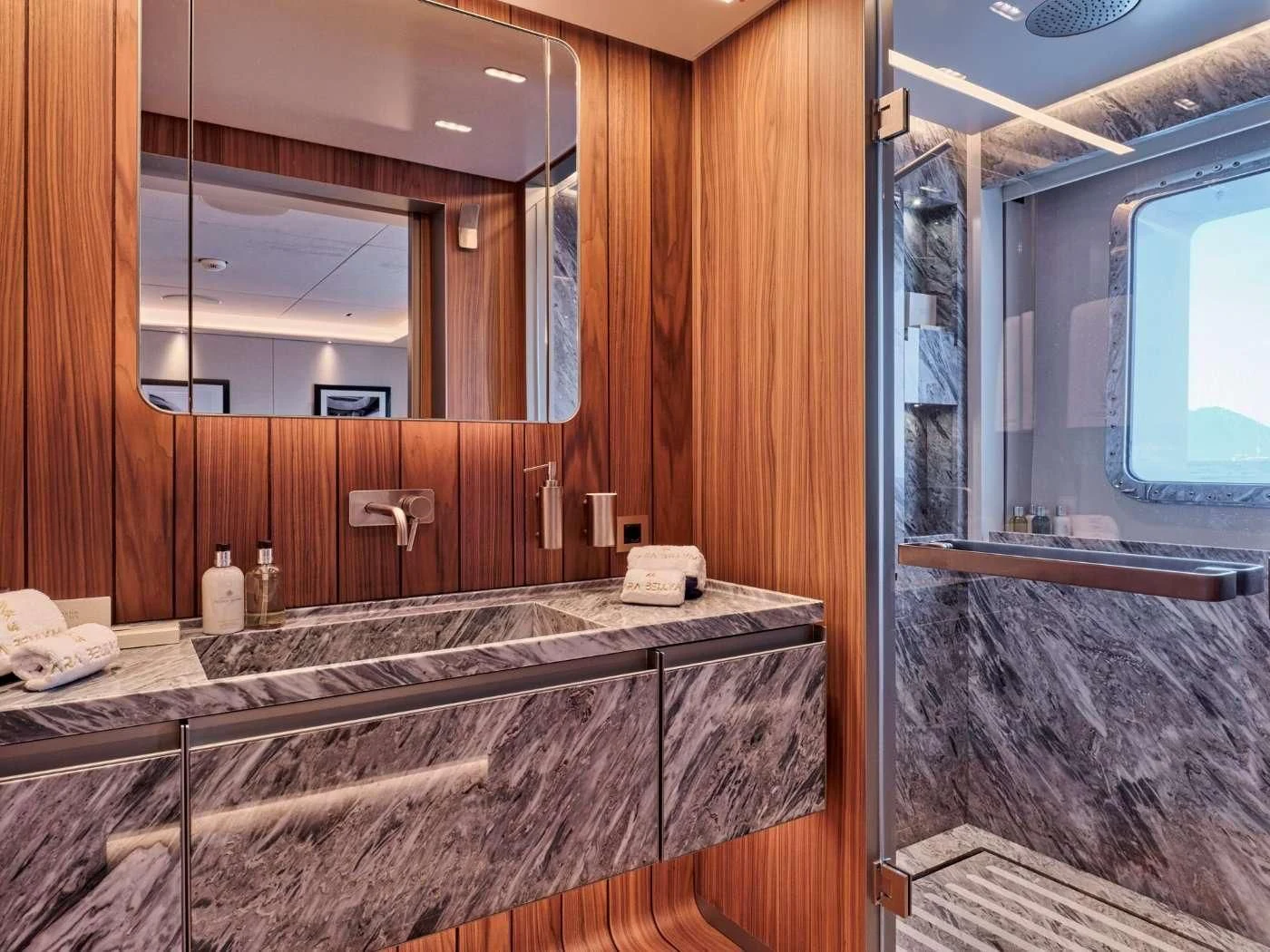 a bathroom with a large mirror aboard PARA BELLVM Yacht for Charter