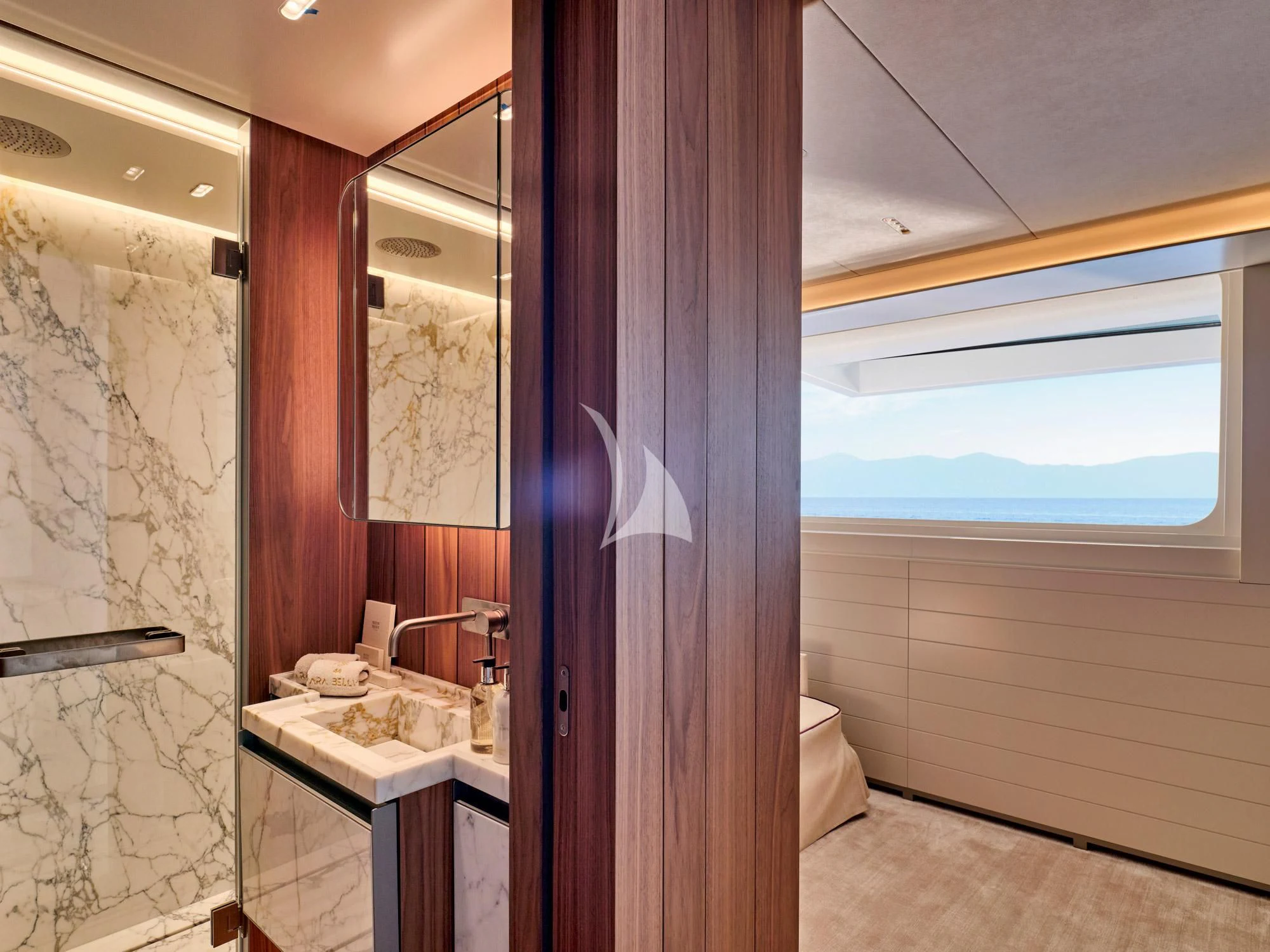 a bathroom with a sink and a shower curtain aboard PARA BELLVM Yacht for Charter