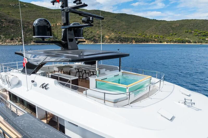 a boat with a large machine on the water aboard PARA BELLVM Yacht for Charter