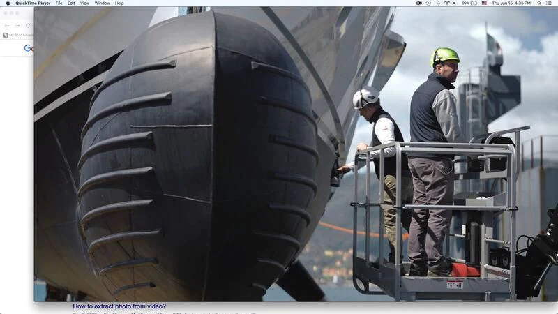 a group of men standing on a ladder next to a large black object aboard PARA BELLVM Yacht for Charter