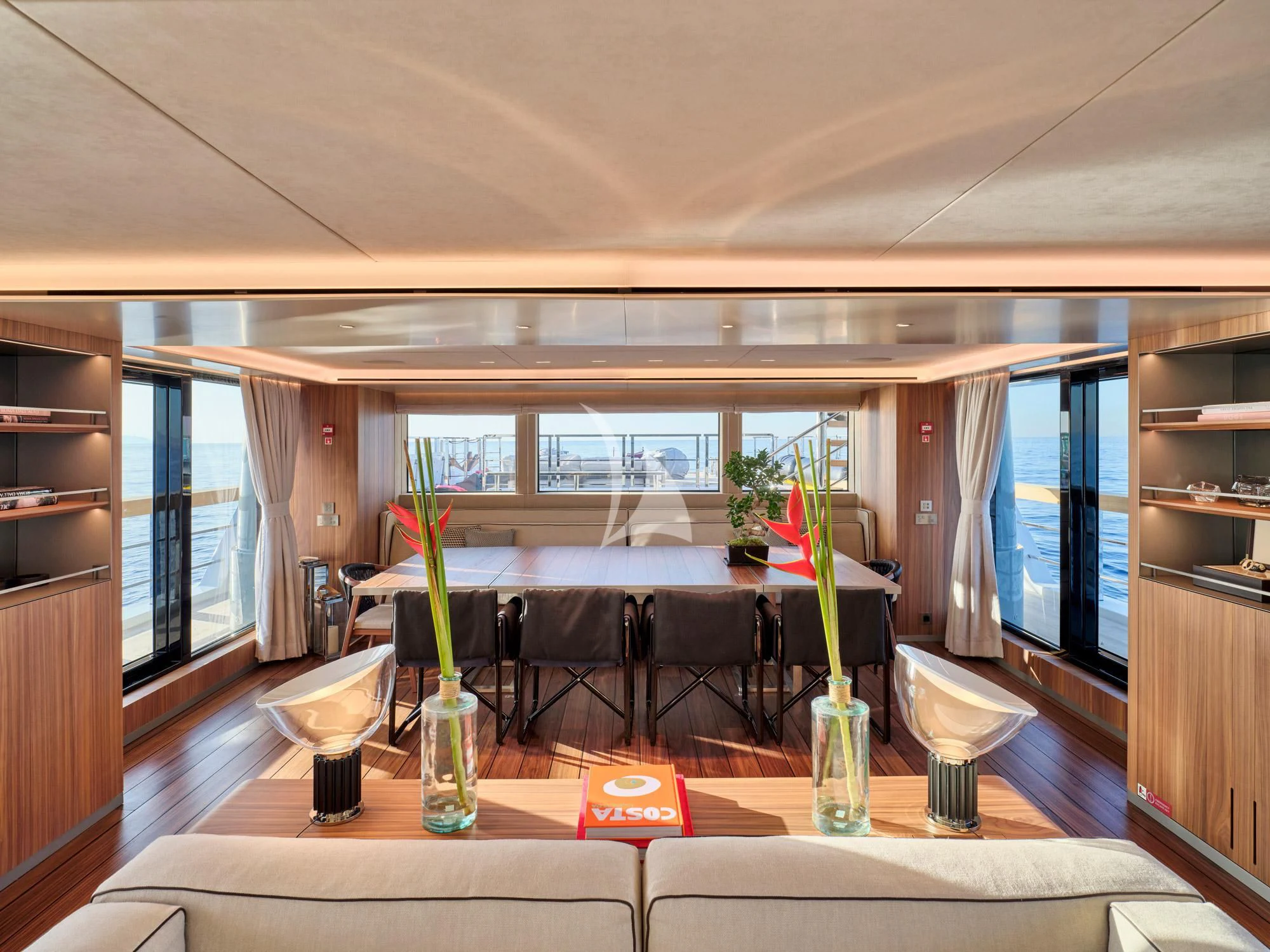 a room with a table and chairs aboard PARA BELLVM Yacht for Charter