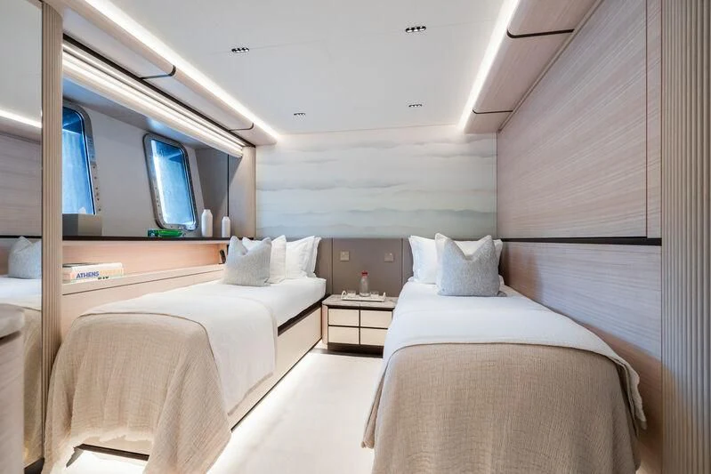 a room with beds and a tv aboard PARA BELLVM Yacht for Charter