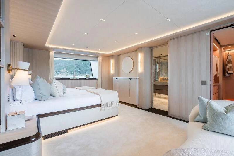 a bedroom with a bed and a window aboard PARA BELLVM Yacht for Charter