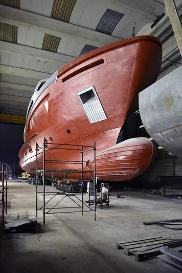 a large red airplane aboard PARA BELLVM Yacht for Charter