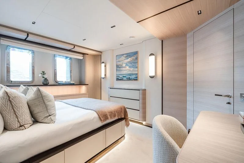 a bedroom with a bed and a desk aboard PARA BELLVM Yacht for Charter