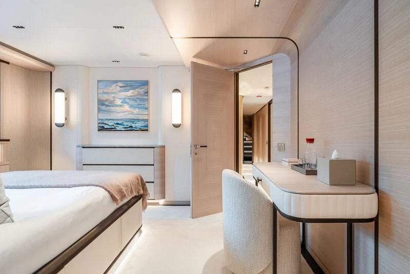 a hotel room with a bed and a table aboard PARA BELLVM Yacht for Charter