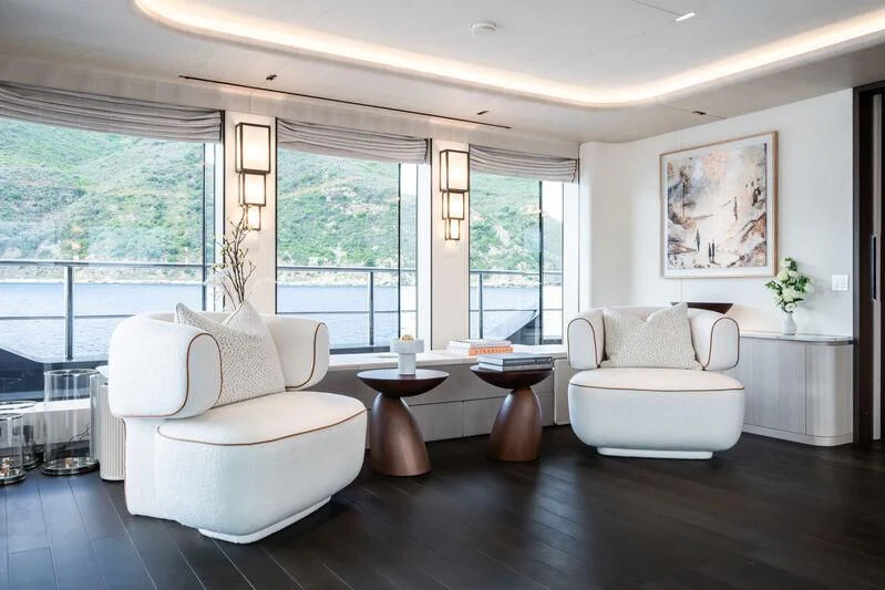 a living room with a large window aboard PARA BELLVM Yacht for Charter