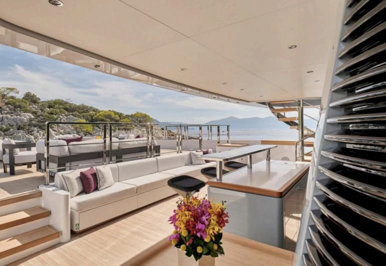 a balcony with a view of the ocean and a pool aboard PARA BELLVM Yacht for Charter