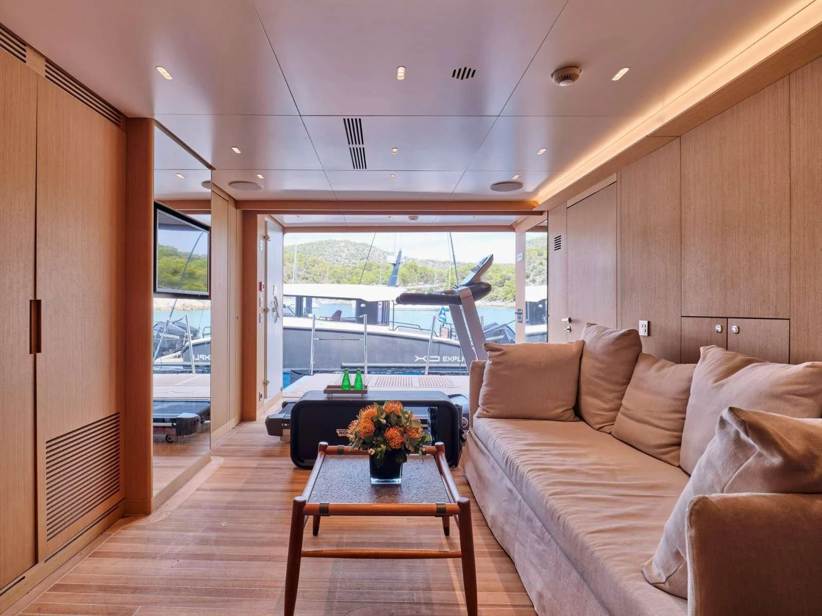 a living room with a large window aboard PARA BELLVM Yacht for Charter