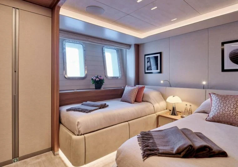 a bedroom with a bed and a window aboard PARA BELLVM Yacht for Charter