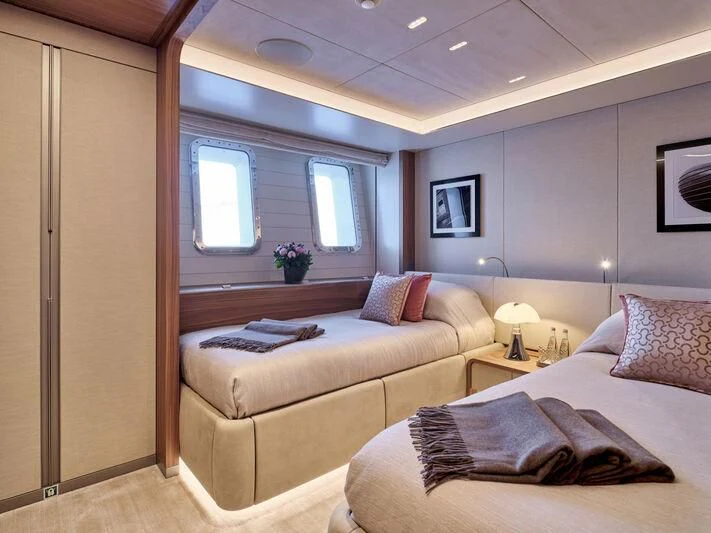 a bedroom with a bed and a desk aboard PARA BELLVM Yacht for Charter