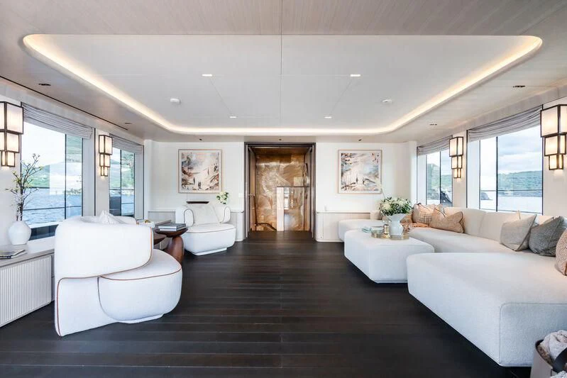 a large living room with white furniture aboard PARA BELLVM Yacht for Charter