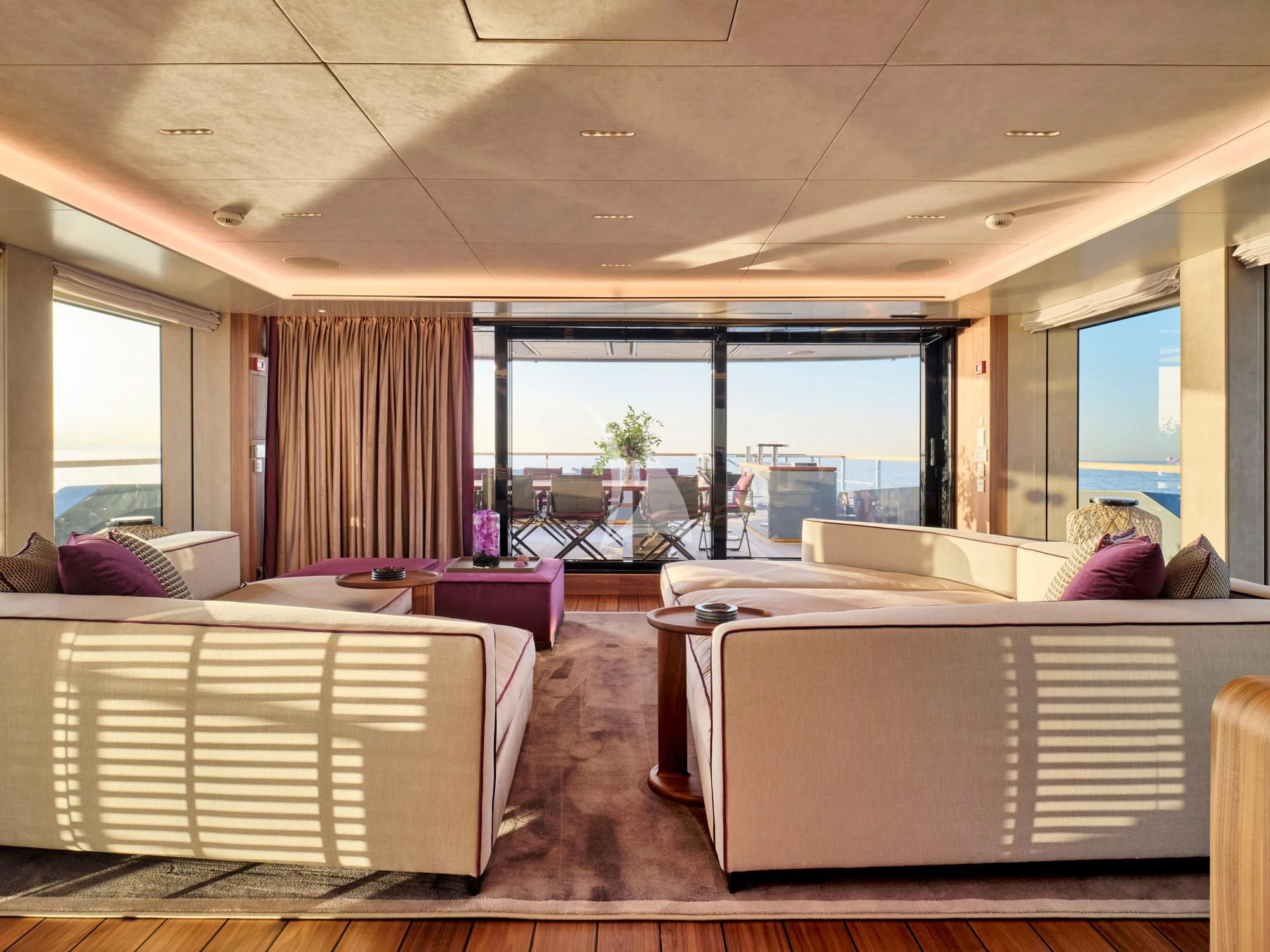 a room with a bed and a large window aboard PARA BELLVM Yacht for Charter