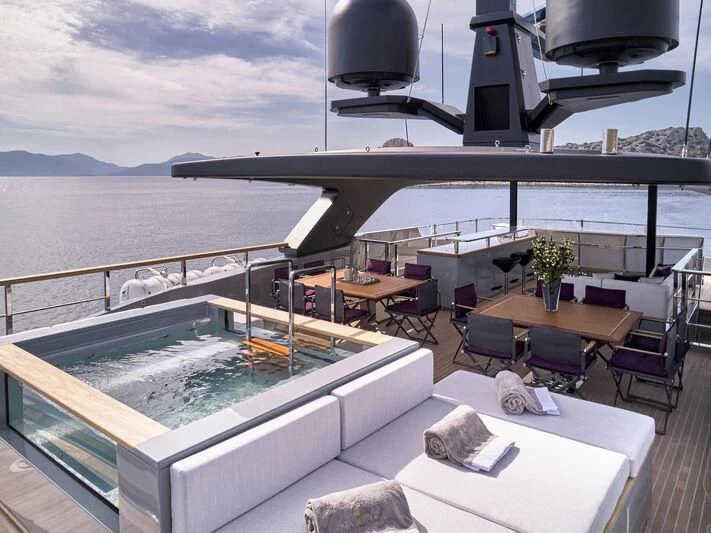 a deck with a large deck and a large boat in the water aboard PARA BELLVM Yacht for Charter