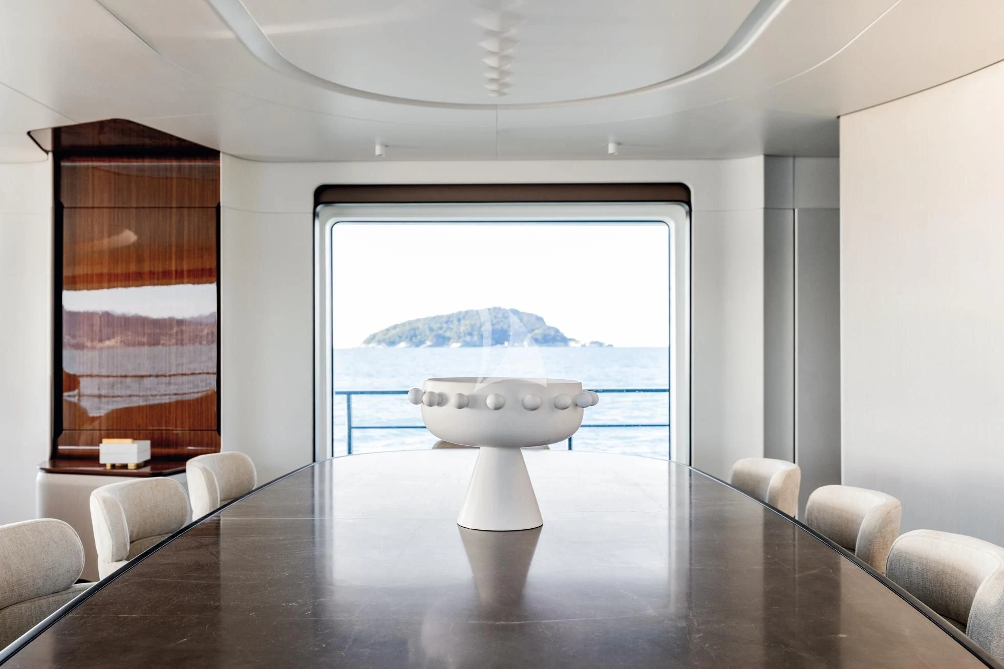 a table with a white table and chairs in front of a window aboard LUZ DE MAR Yacht for Sale