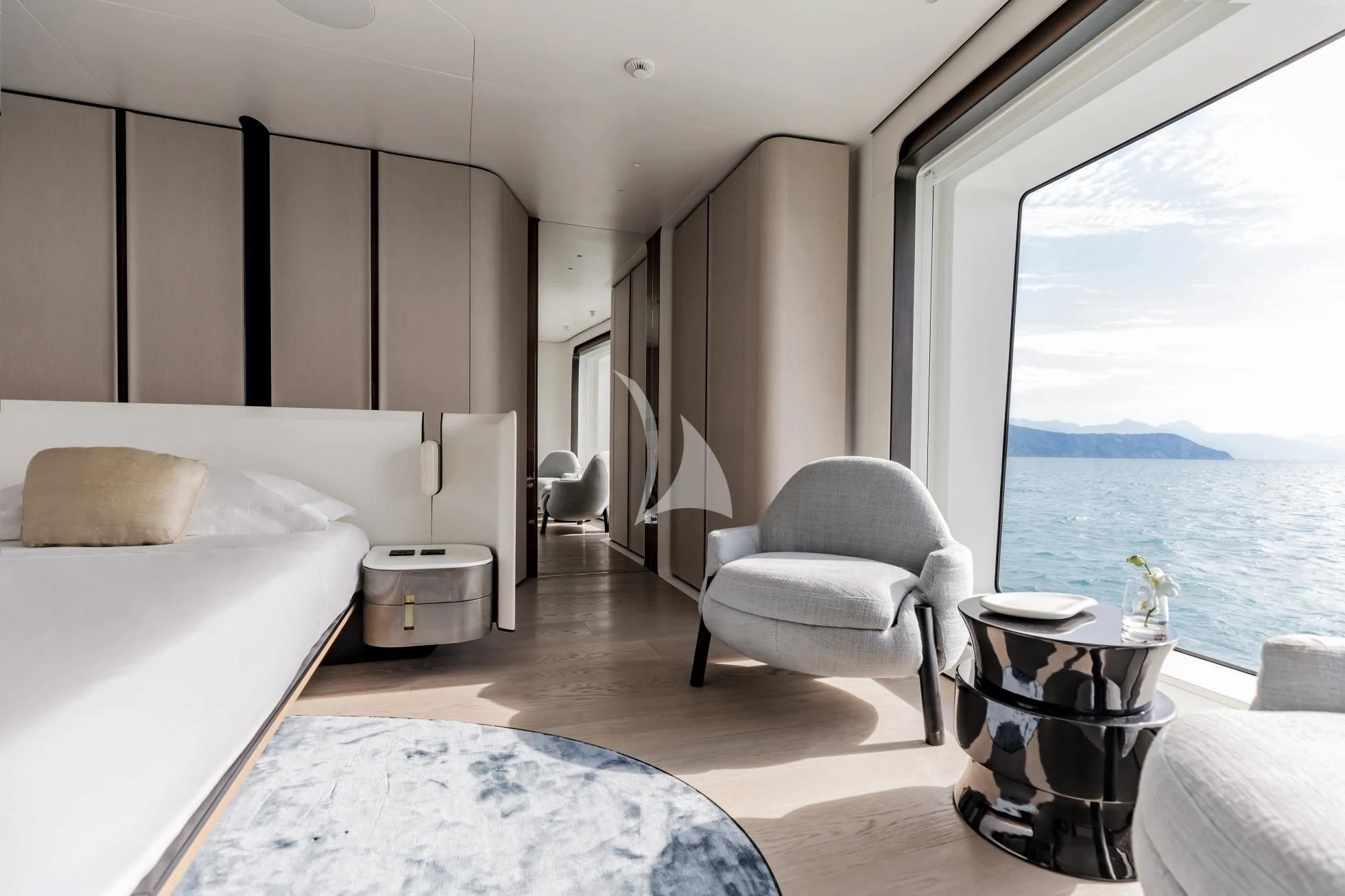 a room with a bed and a chair aboard LUZ DE MAR Yacht for Sale