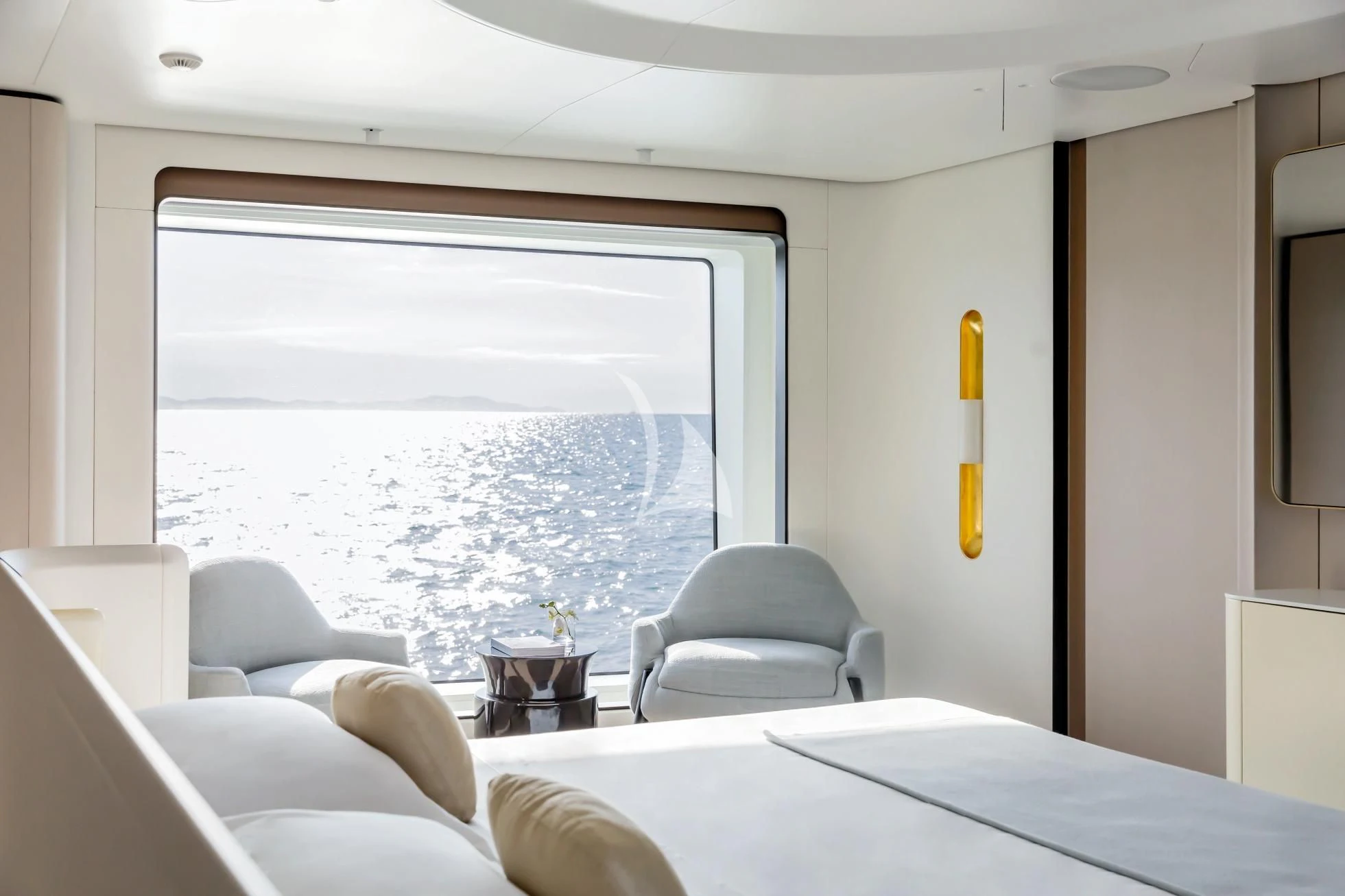 a room with a bed and a chair aboard LUZ DE MAR Yacht for Sale
