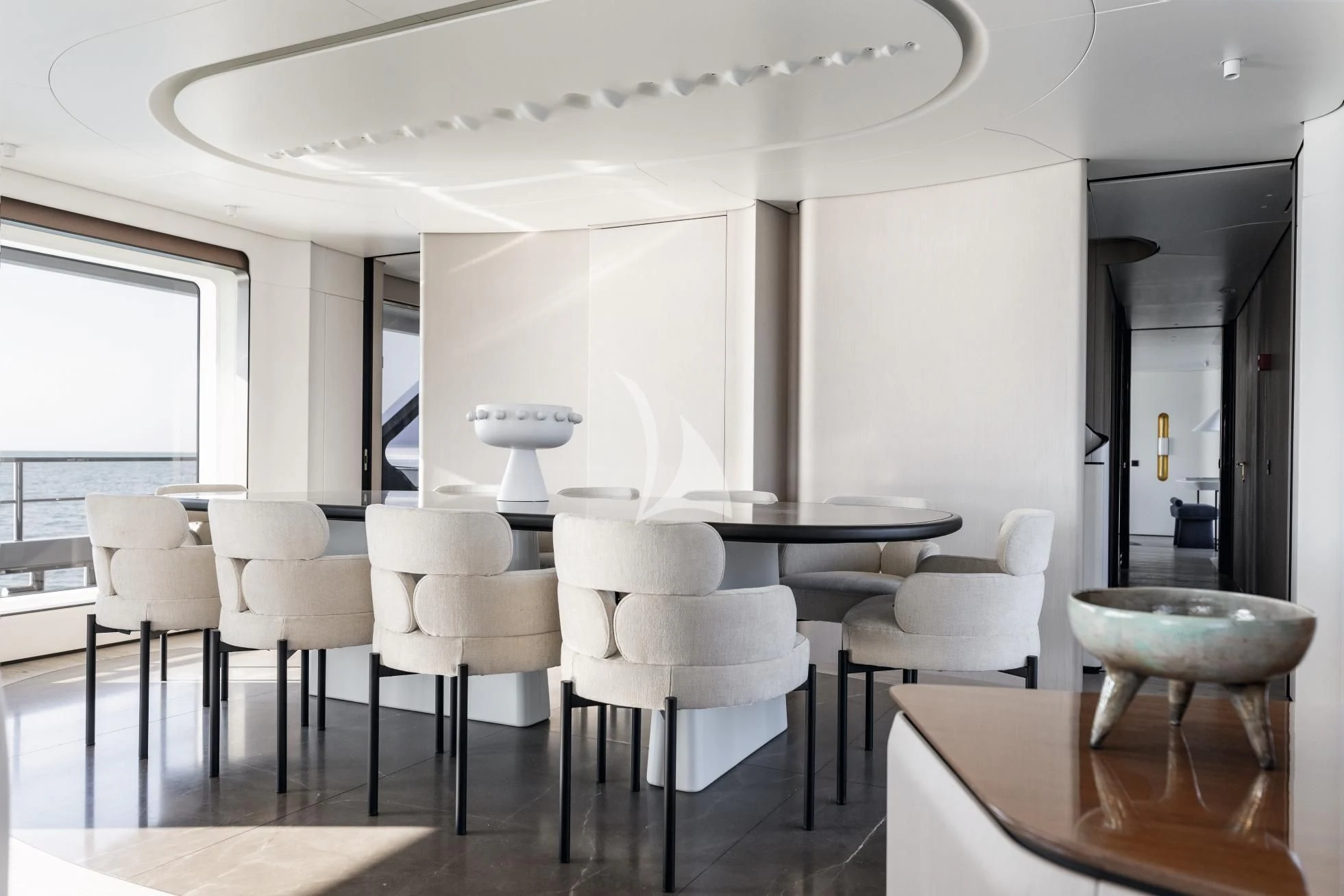 a room with tables and chairs aboard LUZ DE MAR Yacht for Sale