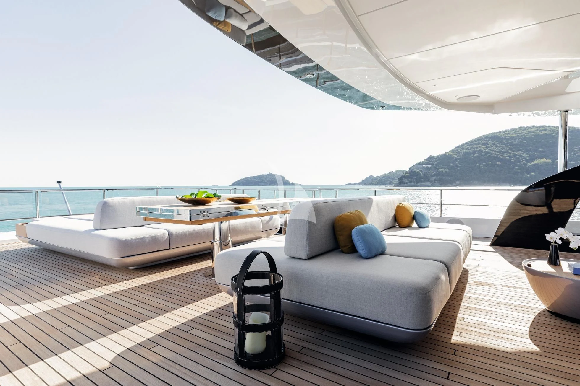 a large white lounge chair on a deck overlooking a large body of water aboard LUZ DE MAR Yacht for Sale