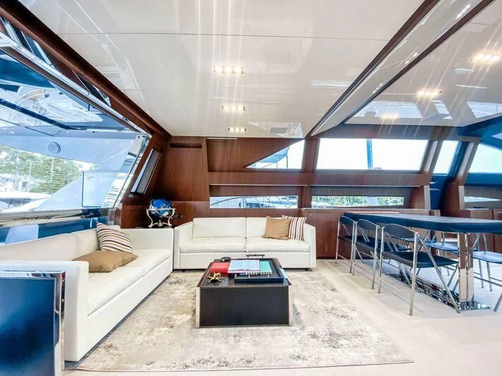 a room with a couch and a table aboard EVENFLOW Yacht for Sale