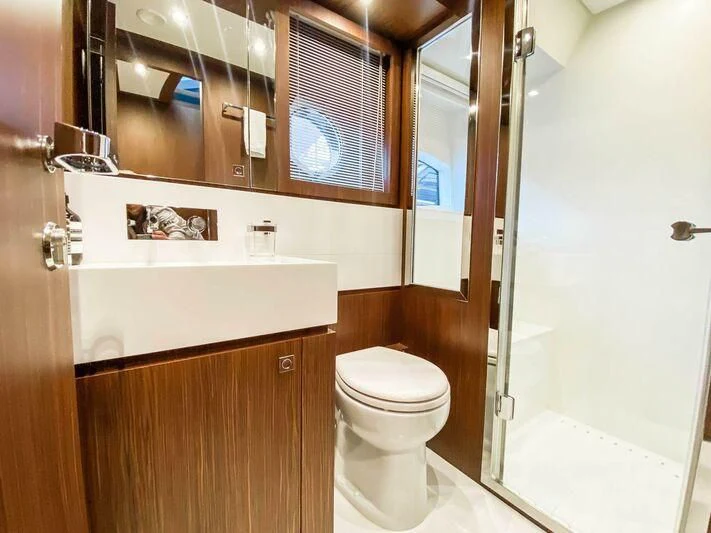 a bathroom with a toilet and a sink aboard EVENFLOW Yacht for Sale