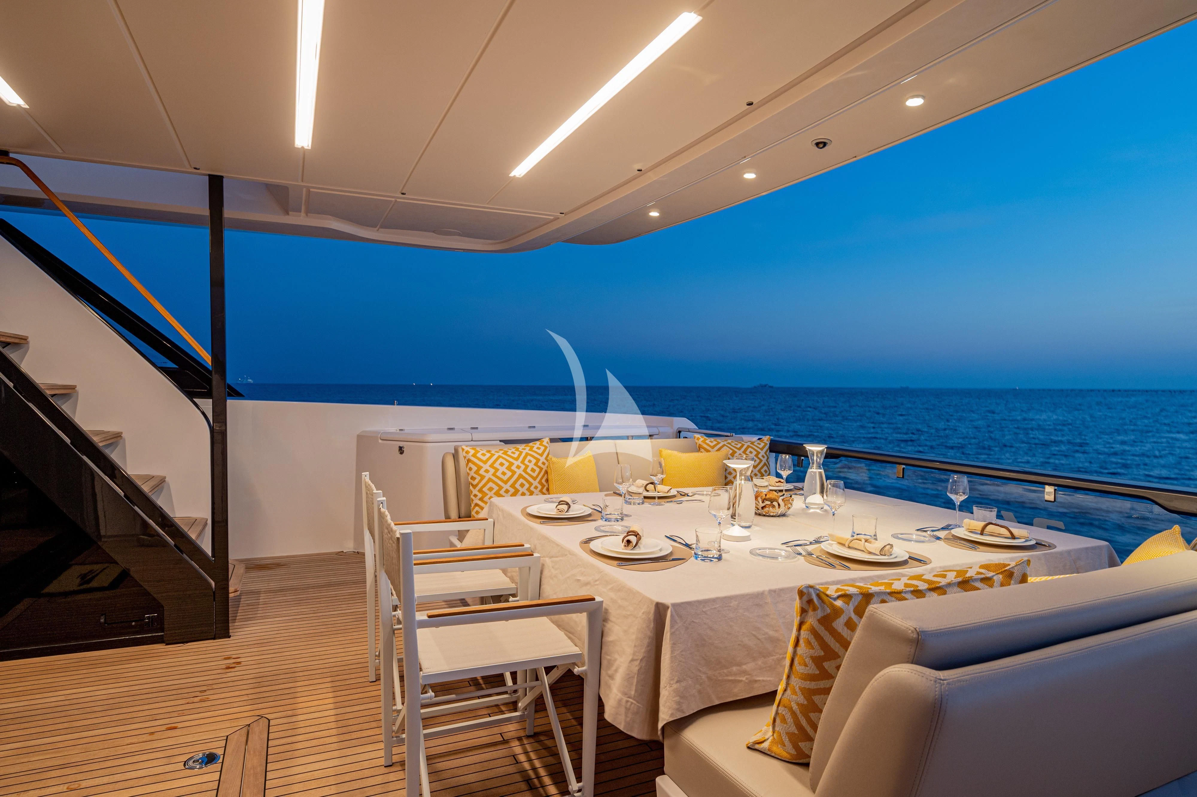 a room with a table chairs and a view of the ocean aboard VITTORIA Yacht for Sale