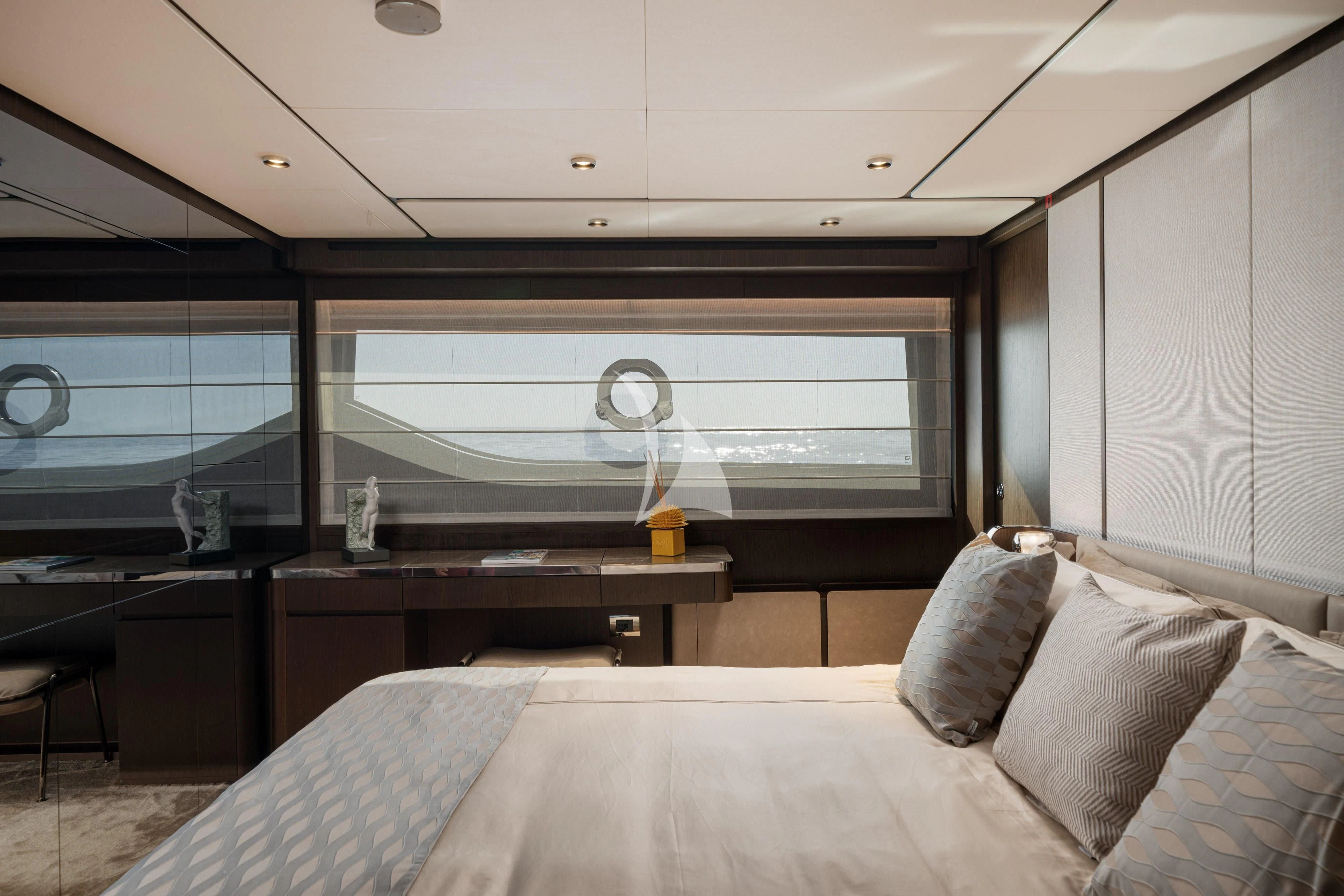 a bedroom with a bed and a desk aboard VITTORIA Yacht for Sale
