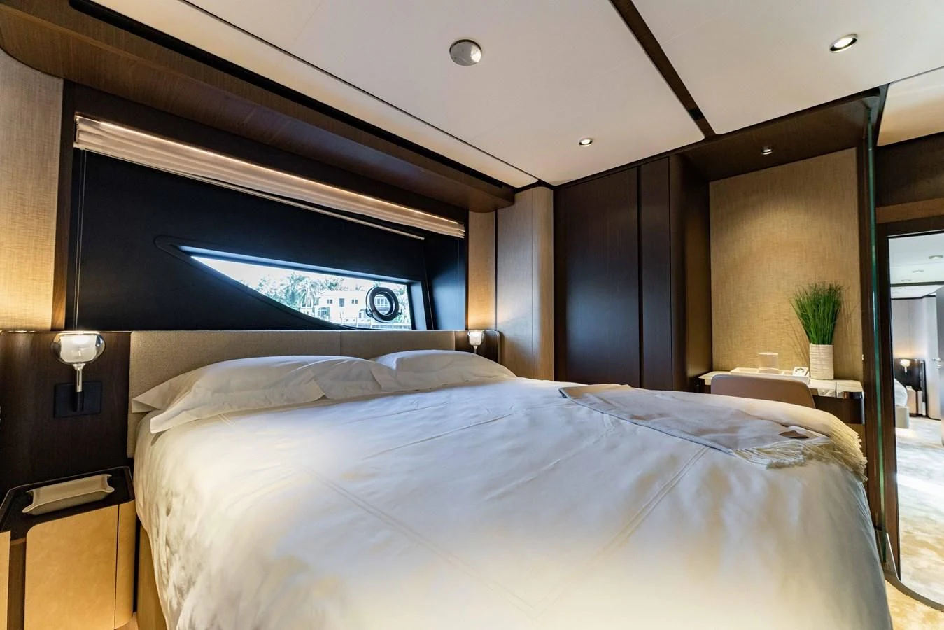 a bed with a white comforter aboard VITTORIA Yacht for Sale