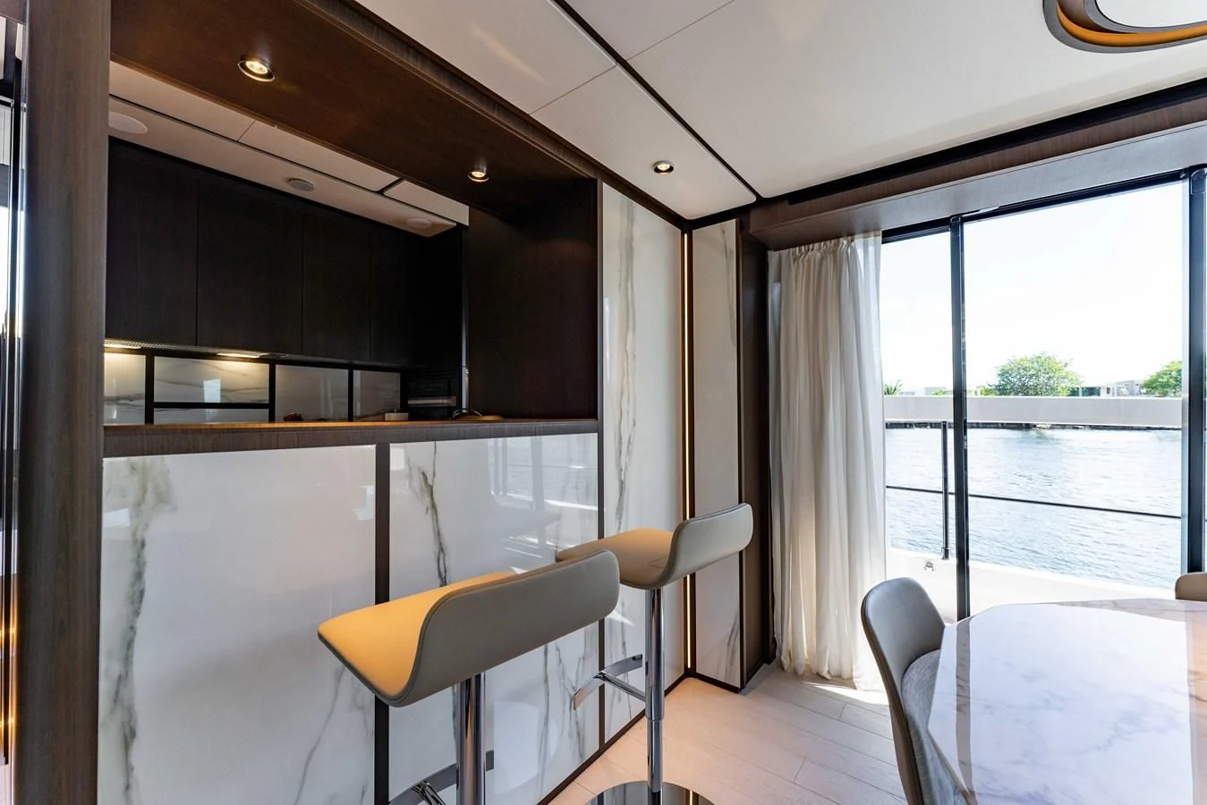 a room with chairs and a table aboard VITTORIA Yacht for Sale