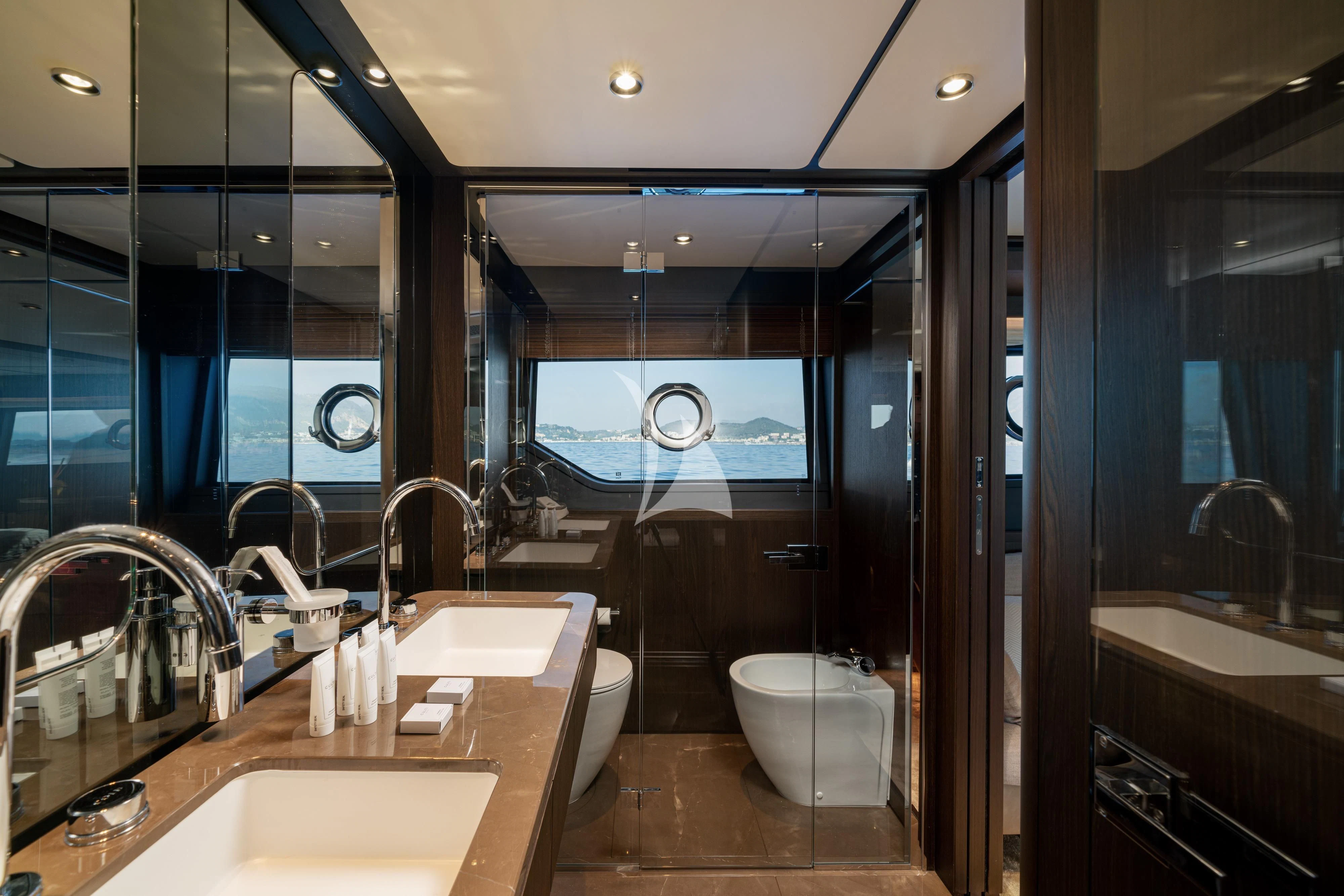 a bathroom with a sink and a large mirror aboard VITTORIA Yacht for Sale