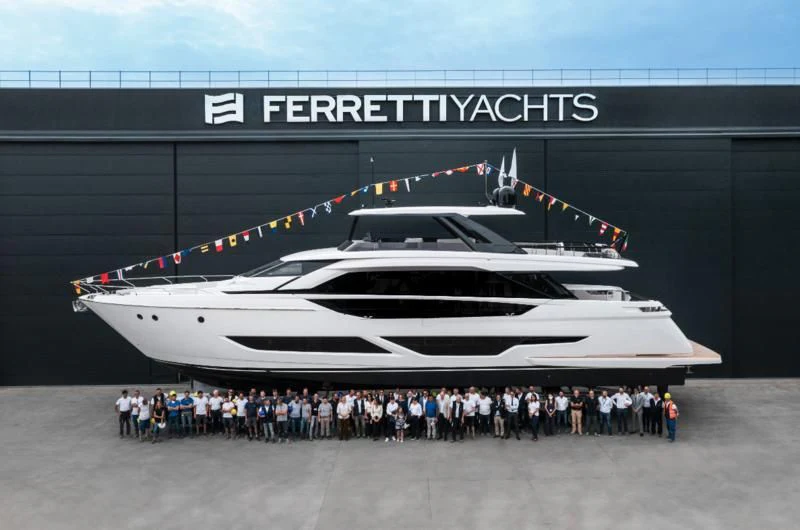 a group of people standing in front of a large white aircraft aboard VITTORIA Yacht for Sale