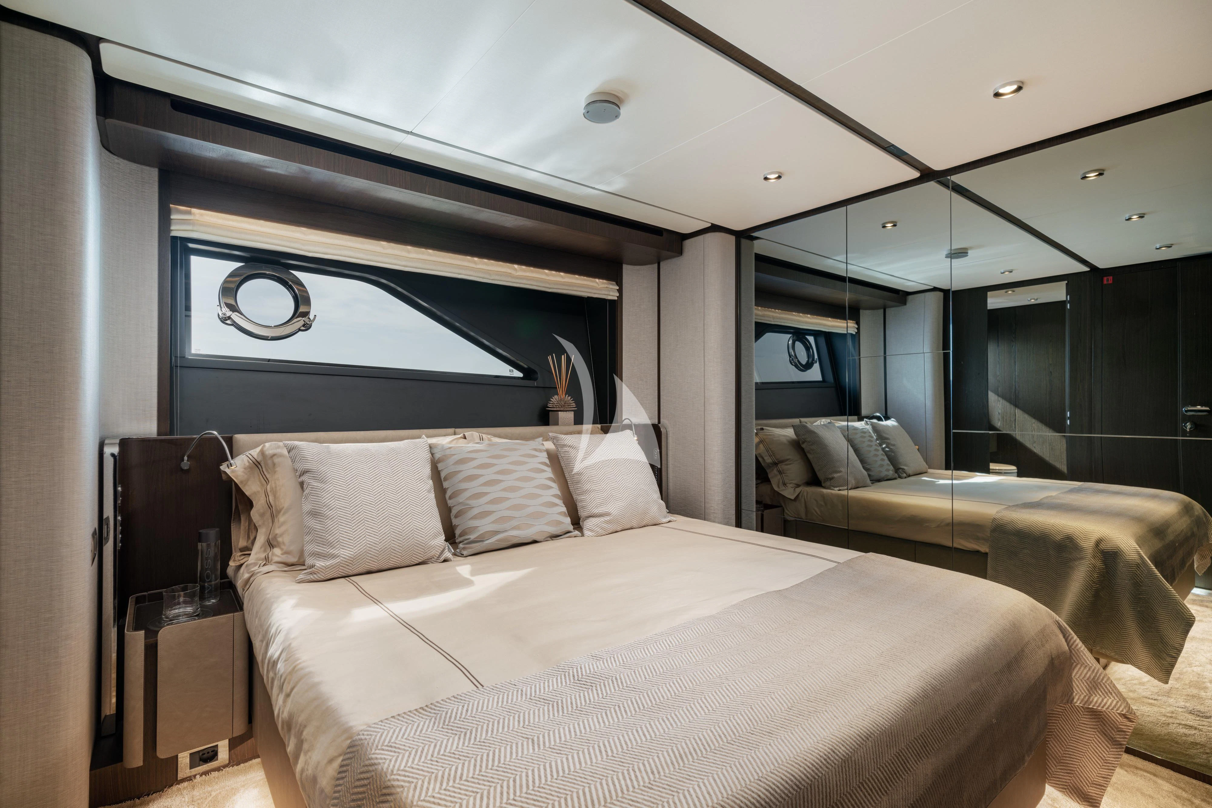 a bedroom with a large mirror aboard VITTORIA Yacht for Sale