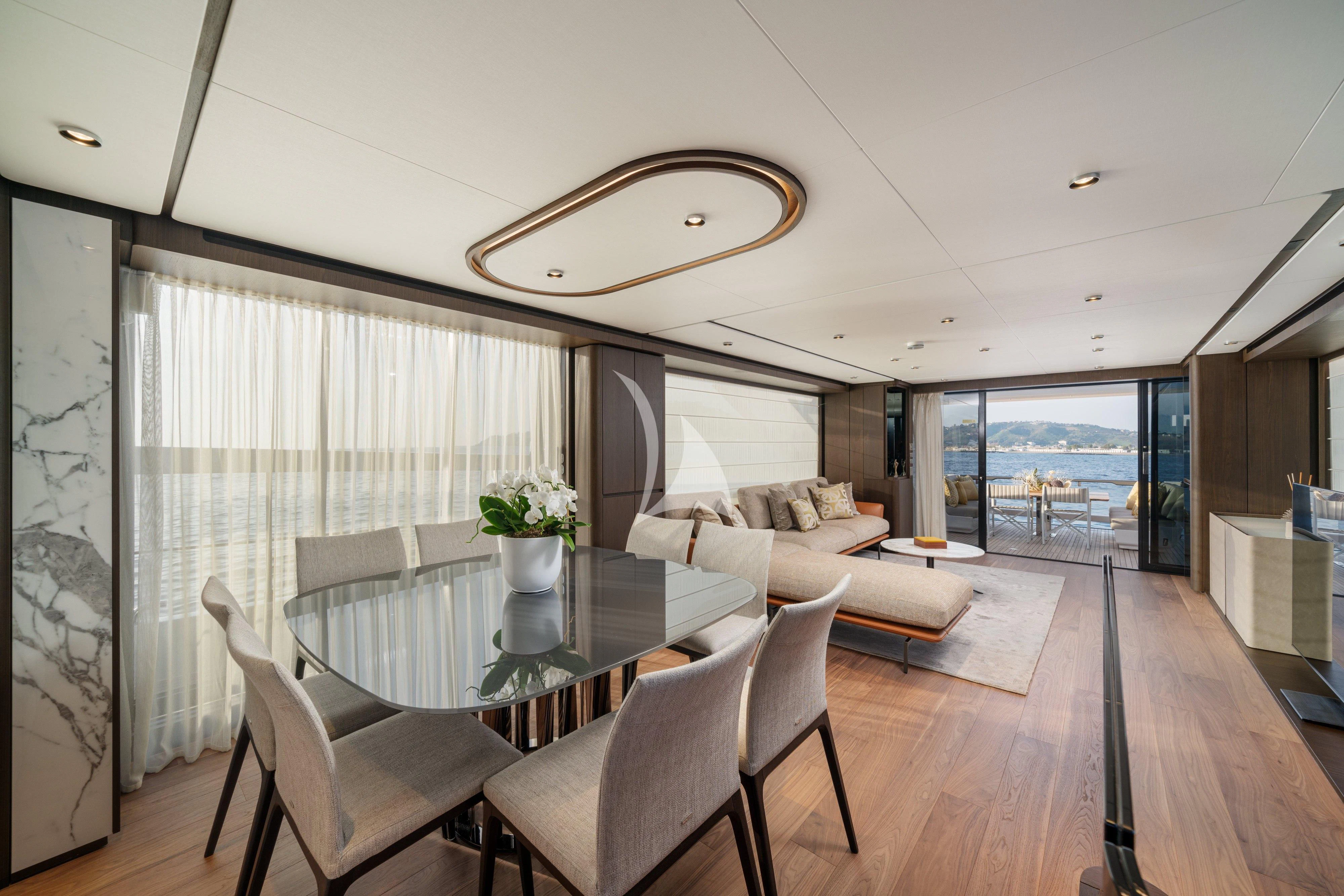 a large living room with a large table and chairs aboard VITTORIA Yacht for Sale
