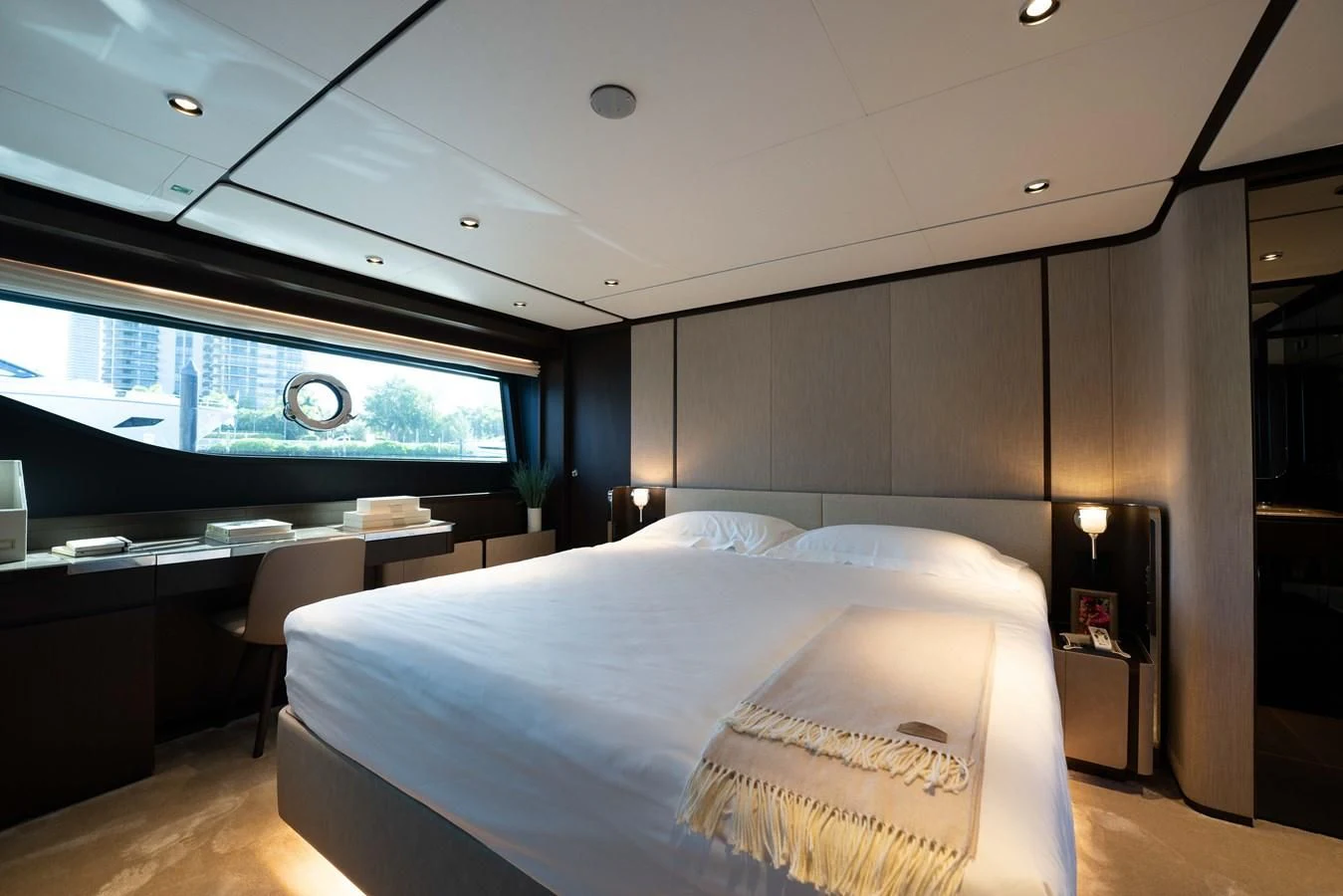 a room with a bed and a large window aboard VITTORIA Yacht for Sale