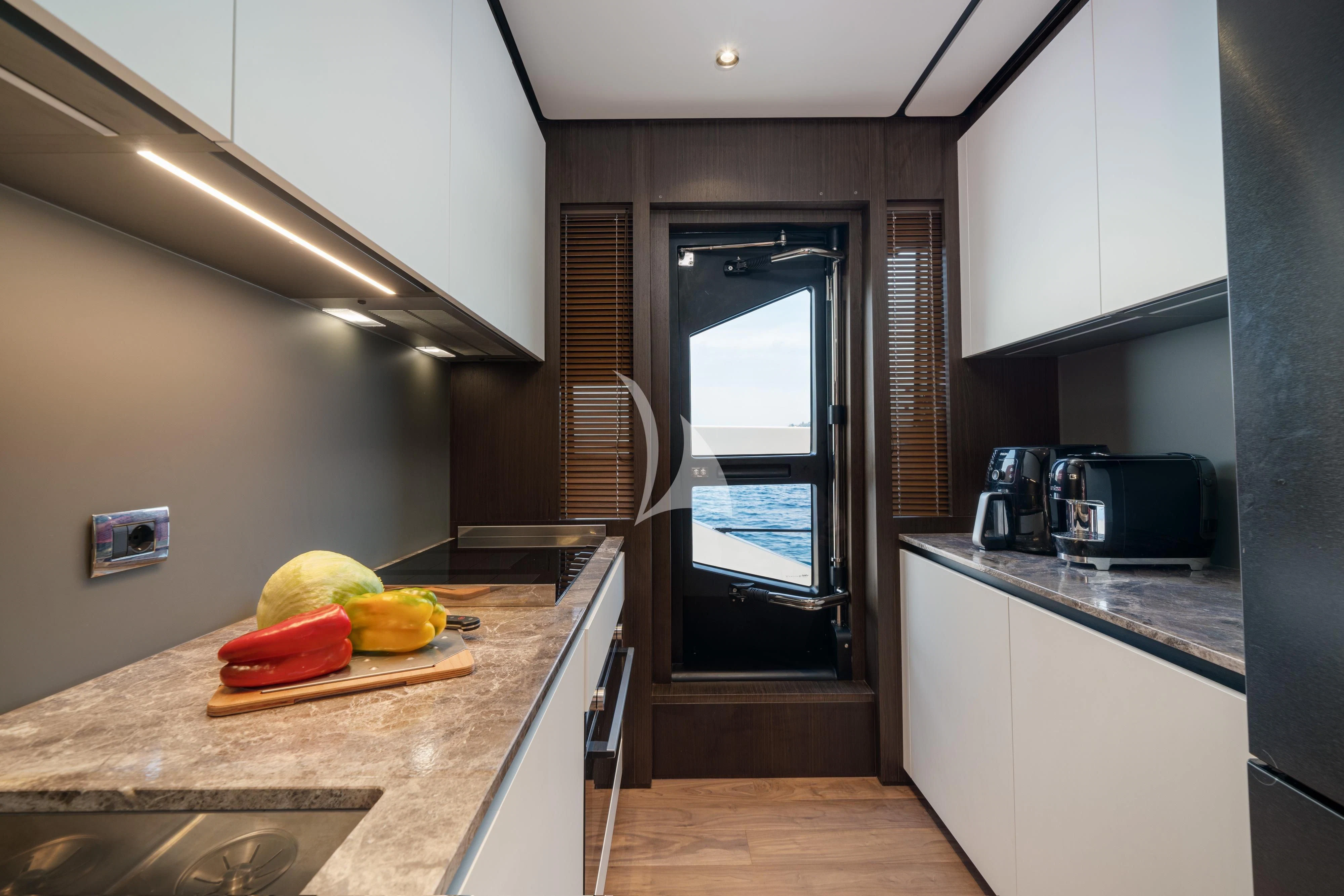 a kitchen with a large island aboard VITTORIA Yacht for Sale