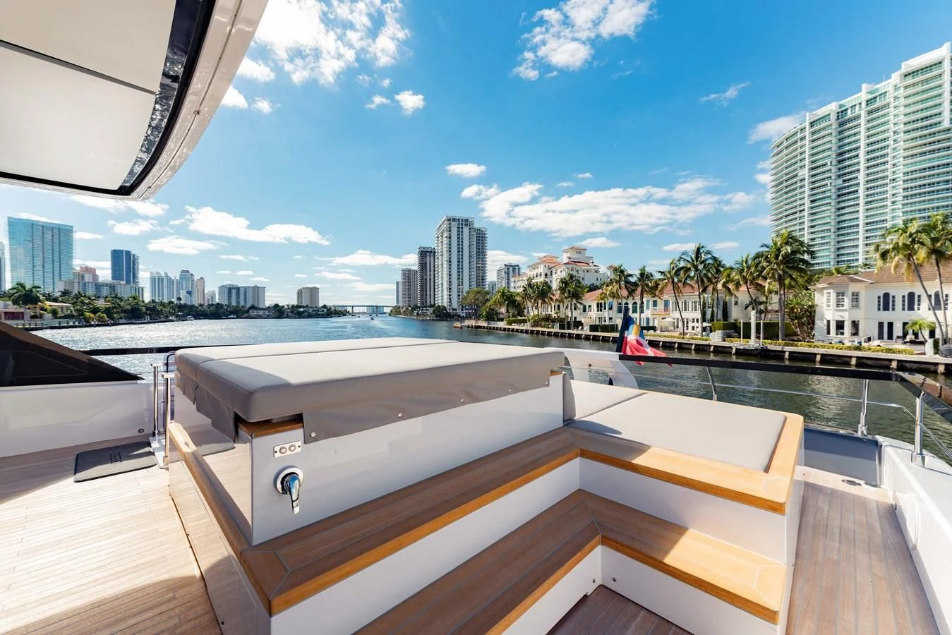 a deck with a view of a city and a body of water aboard VITTORIA Yacht for Sale