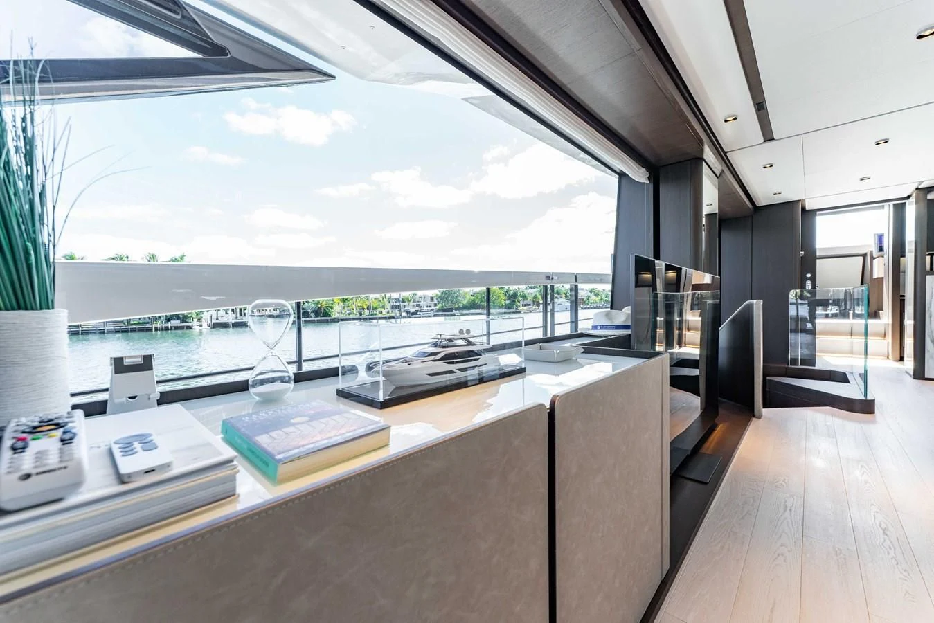 a room with a large window and a table with chairs and a view of the water aboard VITTORIA Yacht for Sale