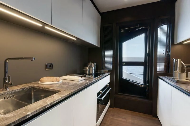 a kitchen with a sink and cabinets aboard VITTORIA Yacht for Sale
