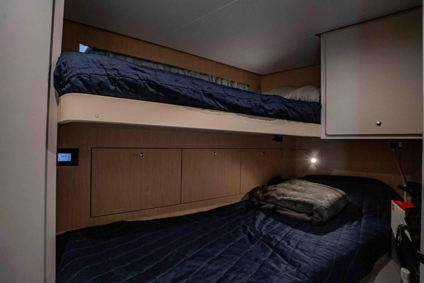 a bed with a blue comforter aboard VITTORIA Yacht for Sale