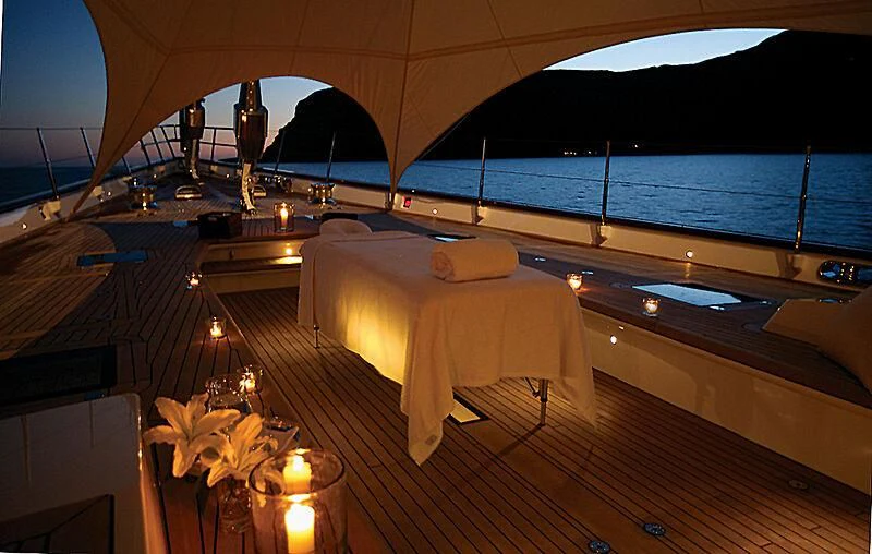 a room with a bed and a large window aboard ETHEREAL Yacht for Sale